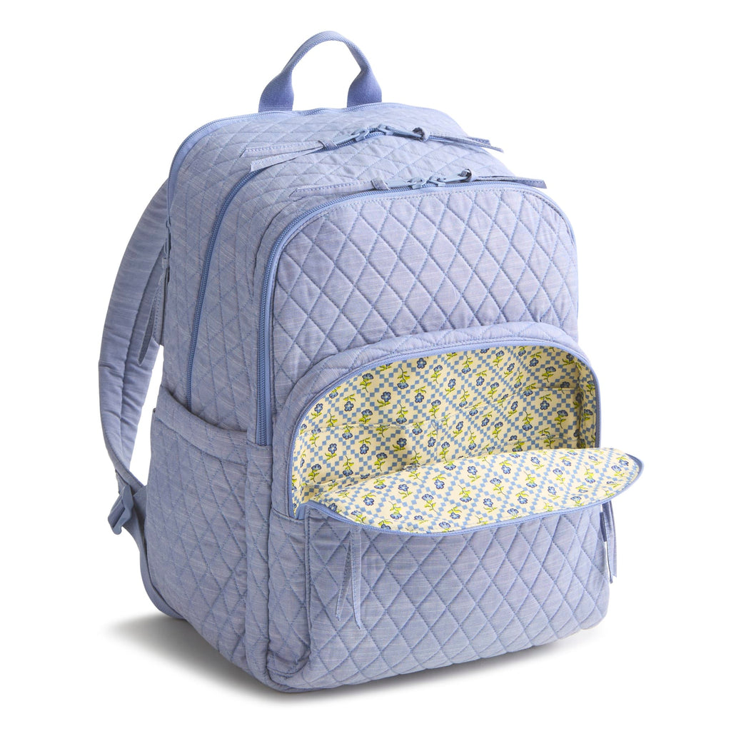 Quilted light blue backpack with floral interior pocket on a white background