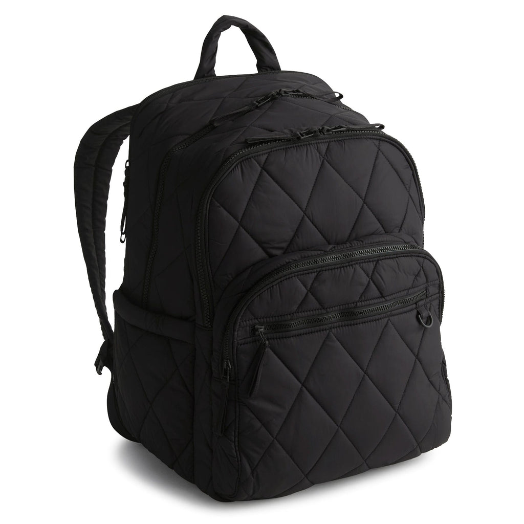 Black quilted backpack on a white background