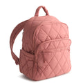 Pink quilted backpack on a white background