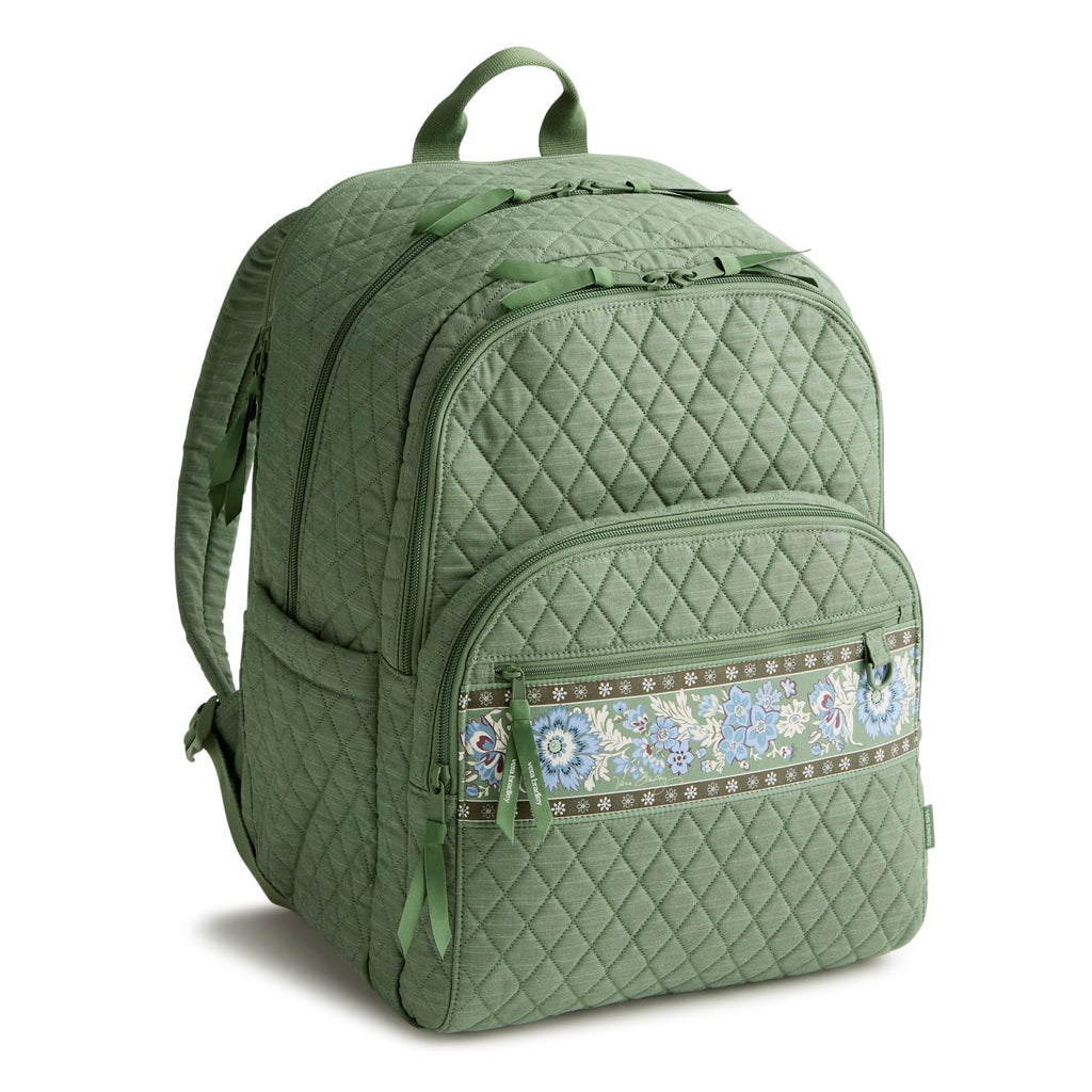 Green quilted backpack with a decorative zipper pull on a white background