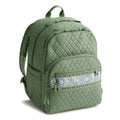 Green quilted backpack with a decorative zipper pull on a white background