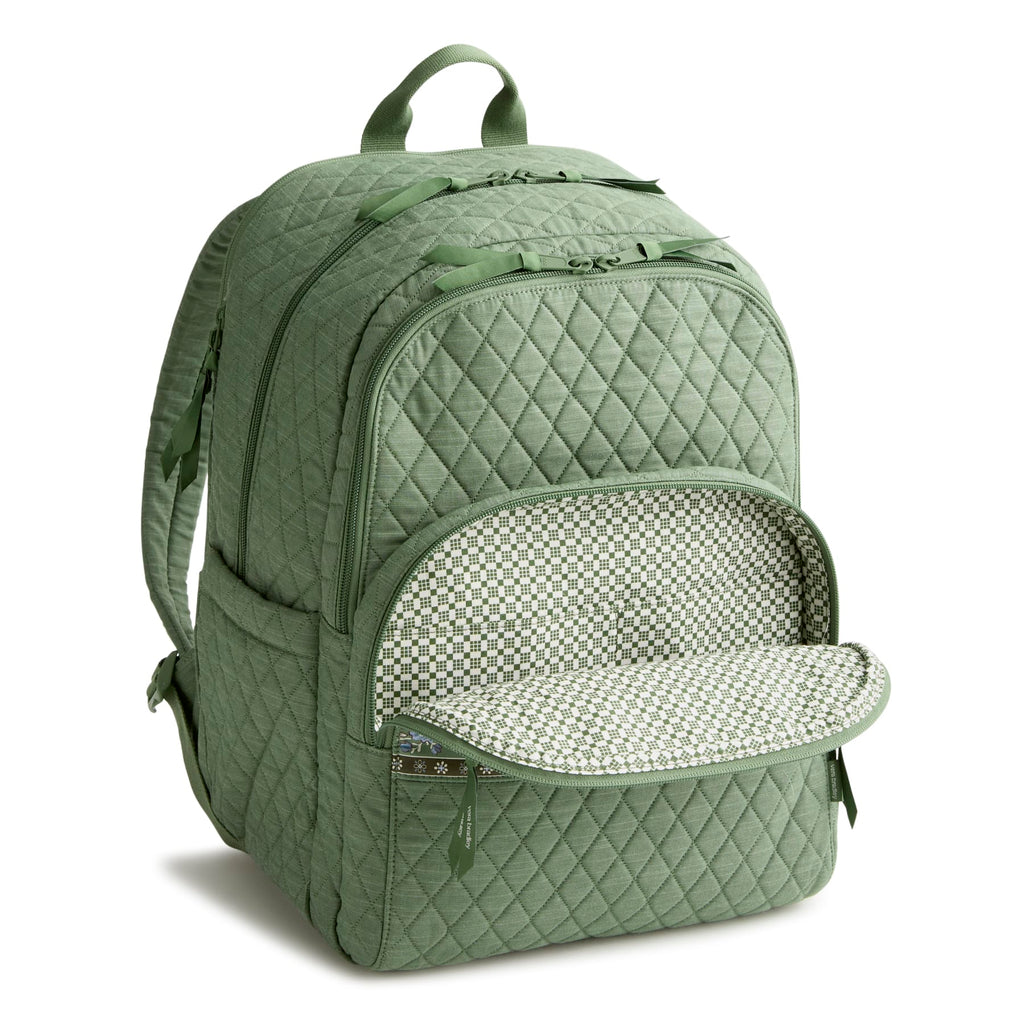 Green quilted backpack with open front compartment on a white background