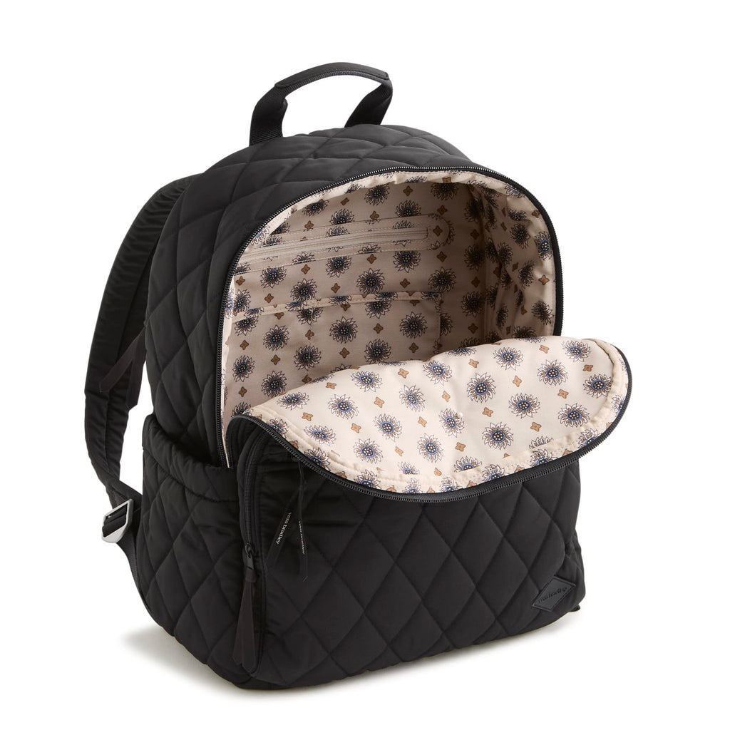 Black quilted backpack with floral interior pocket on a white background