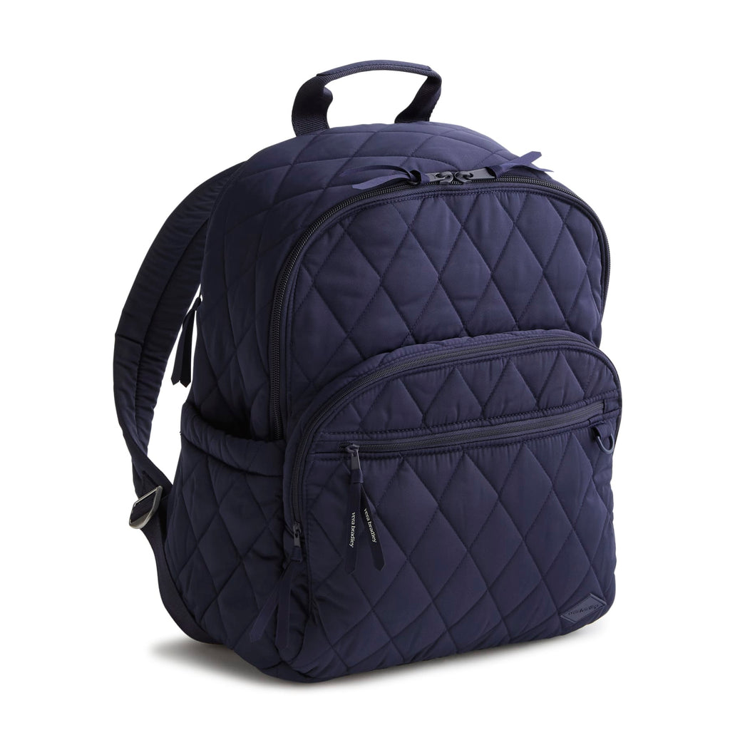 Navy blue quilted backpack on a white background