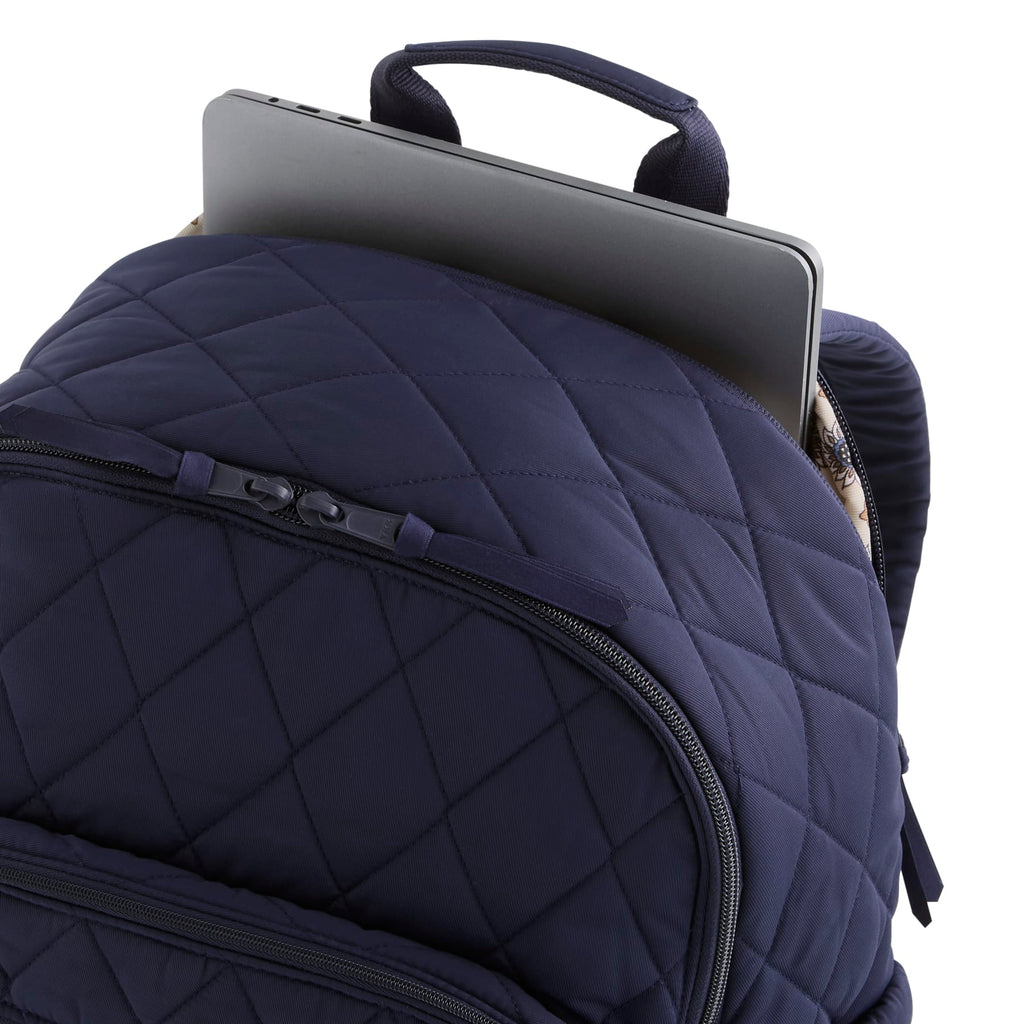 Navy blue quilted backpack with a laptop compartment on a white background
